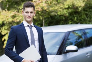 beautiful young insurance agent watching straight in camera